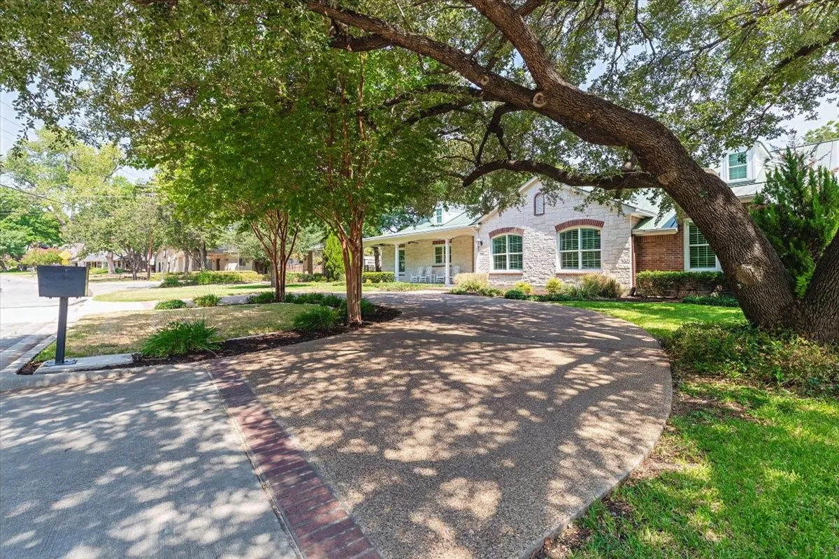 Stone and brick exterior with a curved driveway