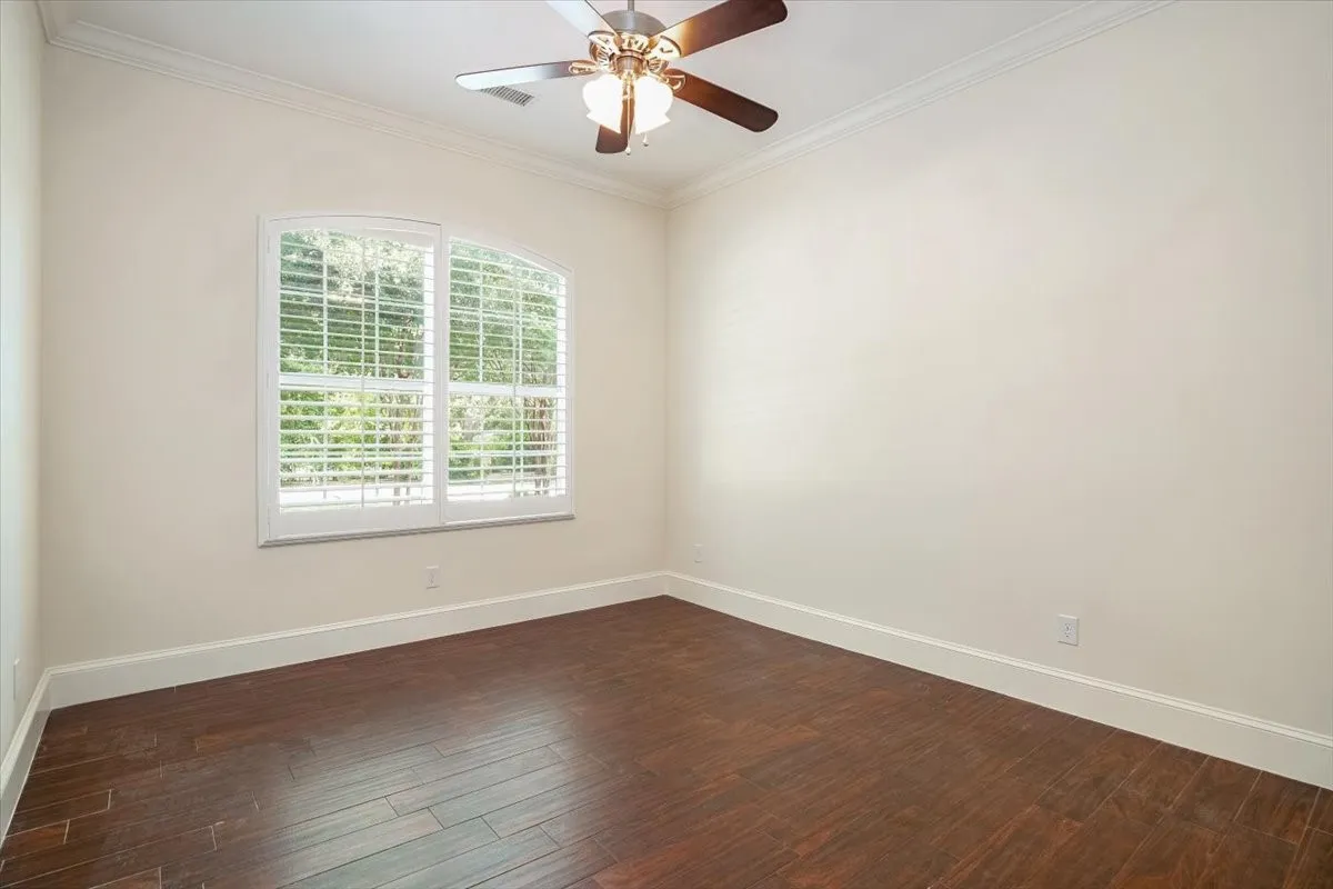 With crown molding, and a ceiling fan with light fixture