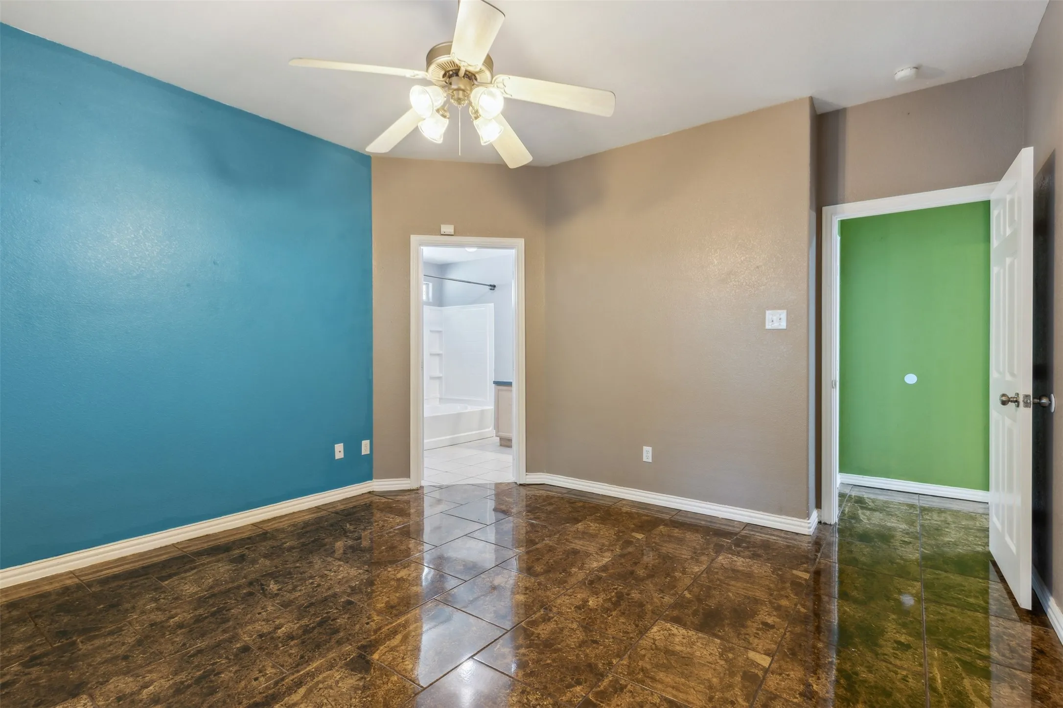 Tiled spare room with ceiling fan