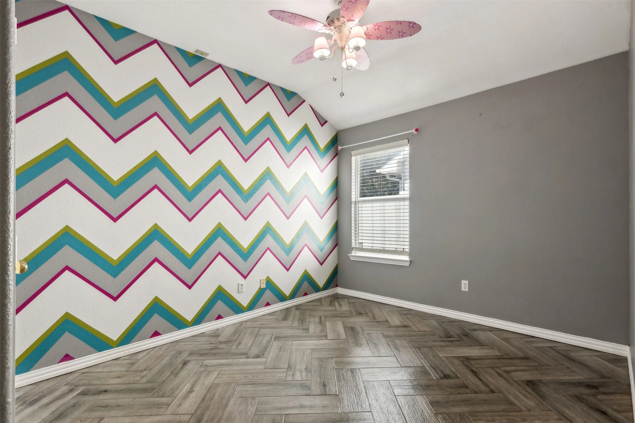 Spare room featuring ceiling fan and parquet flooring