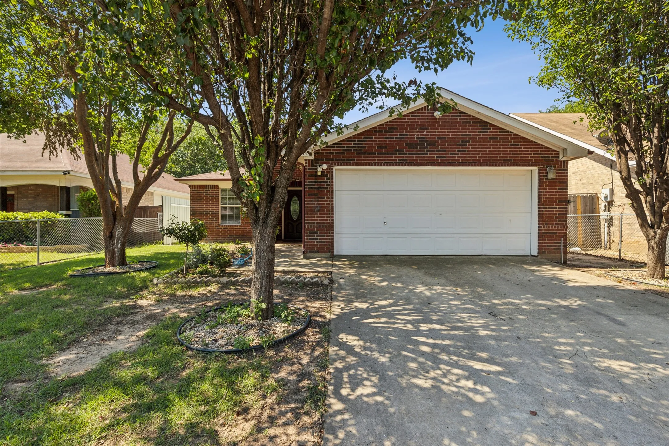 Single story home with a garage and a front lawn