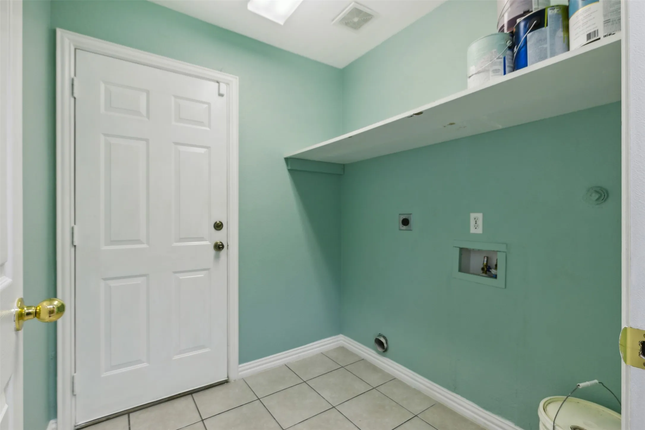 Washroom featuring tile floors, hookup for an electric dryer, and washer hookup