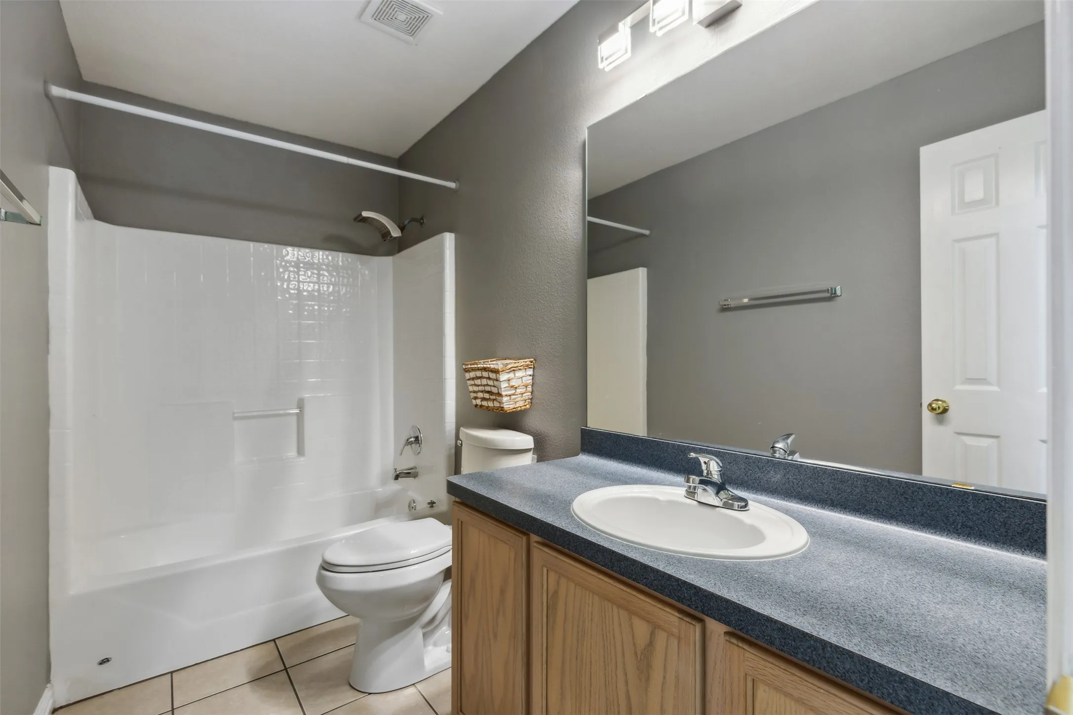 Full bathroom featuring tile flooring, shower / bathing tub combination, toilet, and vanity