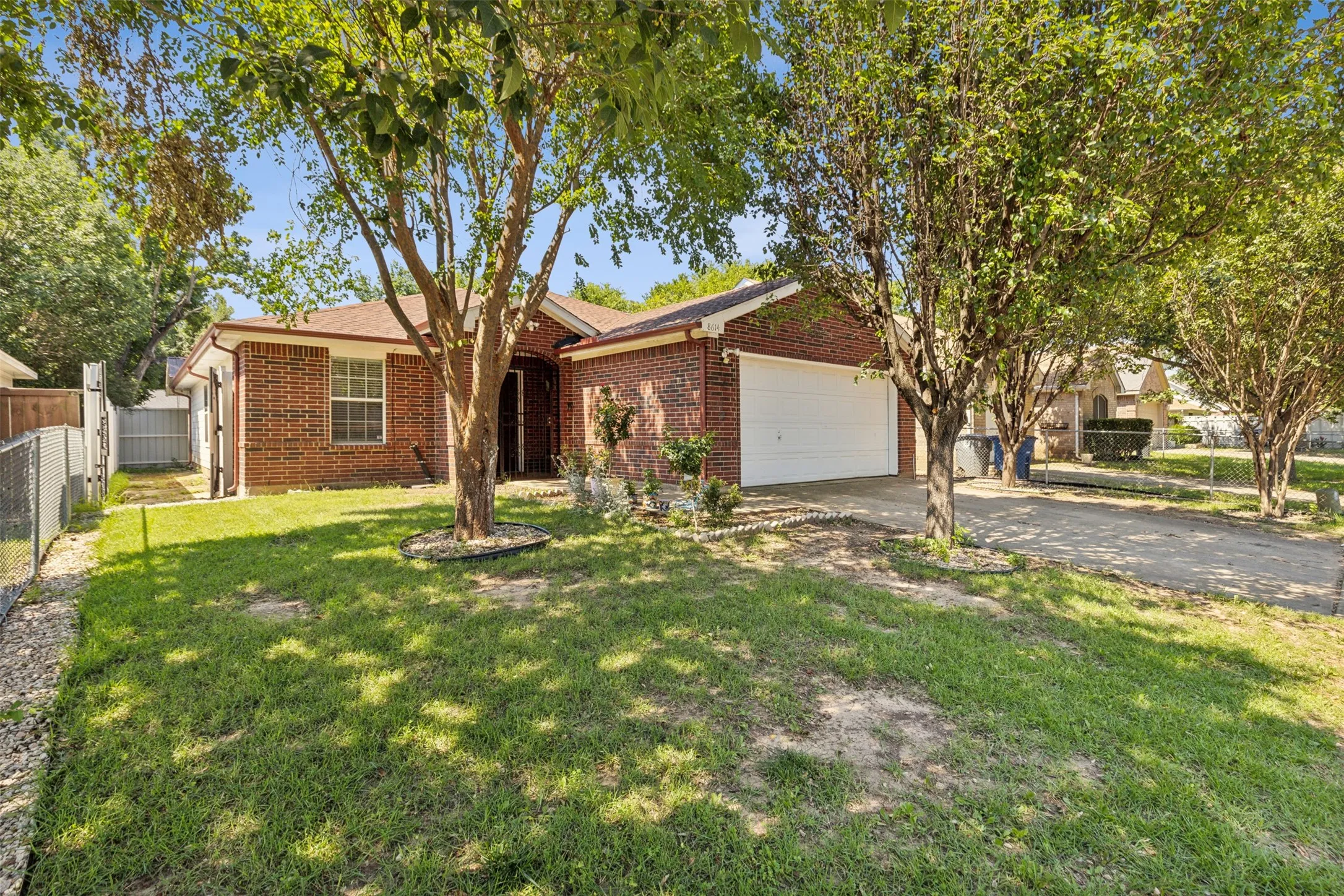 Single story home with a garage and a front yard