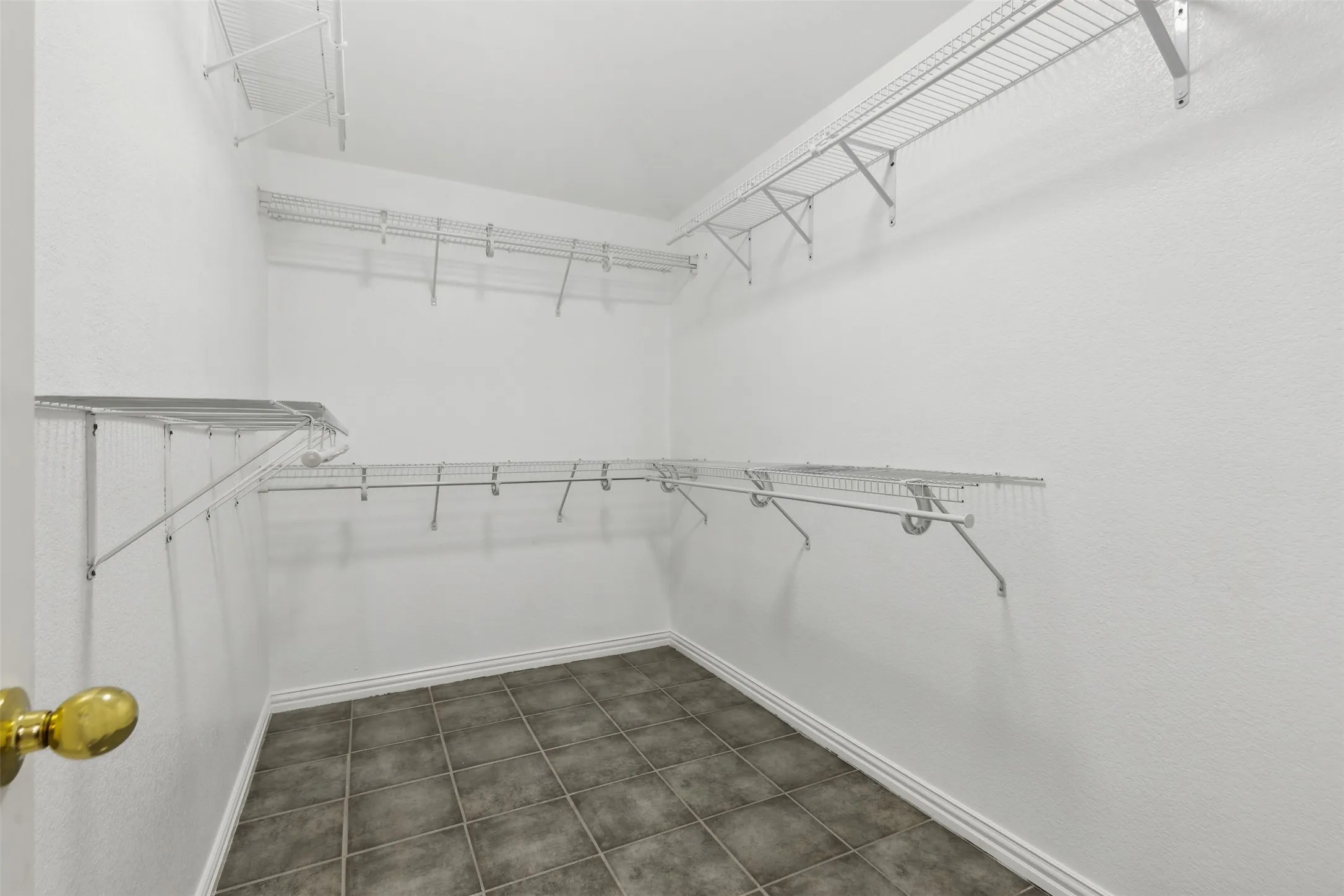 Walk in closet with tile floors