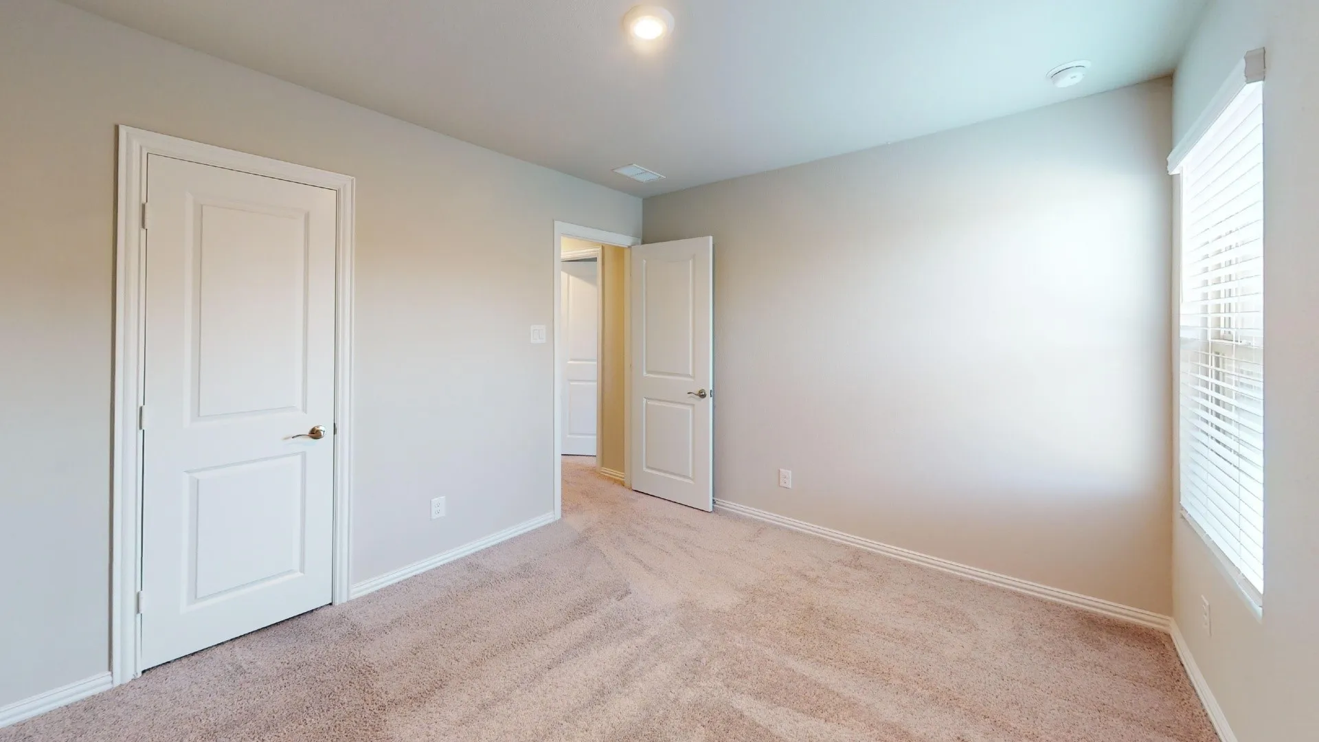 Neutral-toned carpeting paired with light-colored wall paint