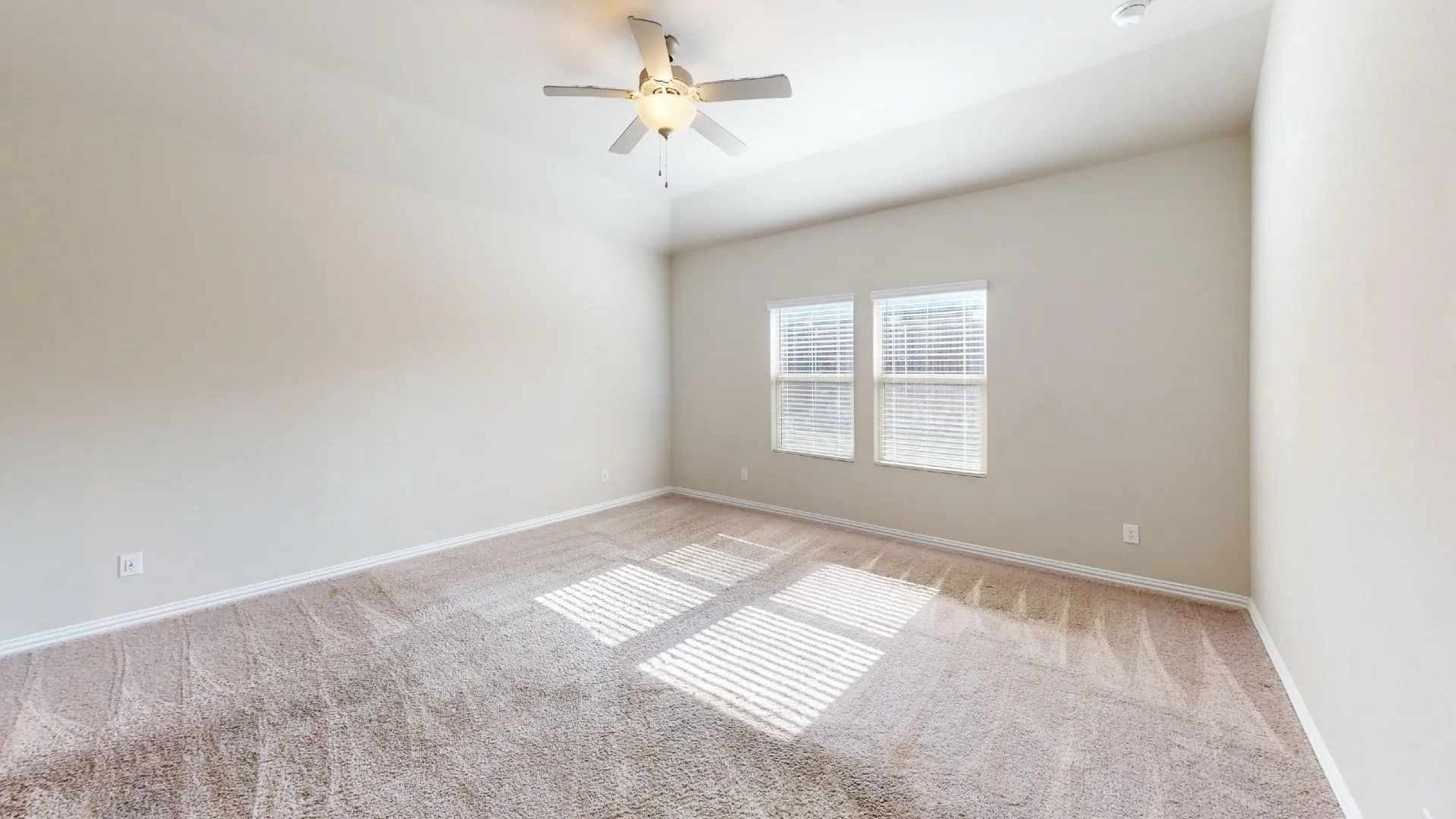 Vaulted ceiling, ceiling fan, carpet flooring, dual windows, and window blinds