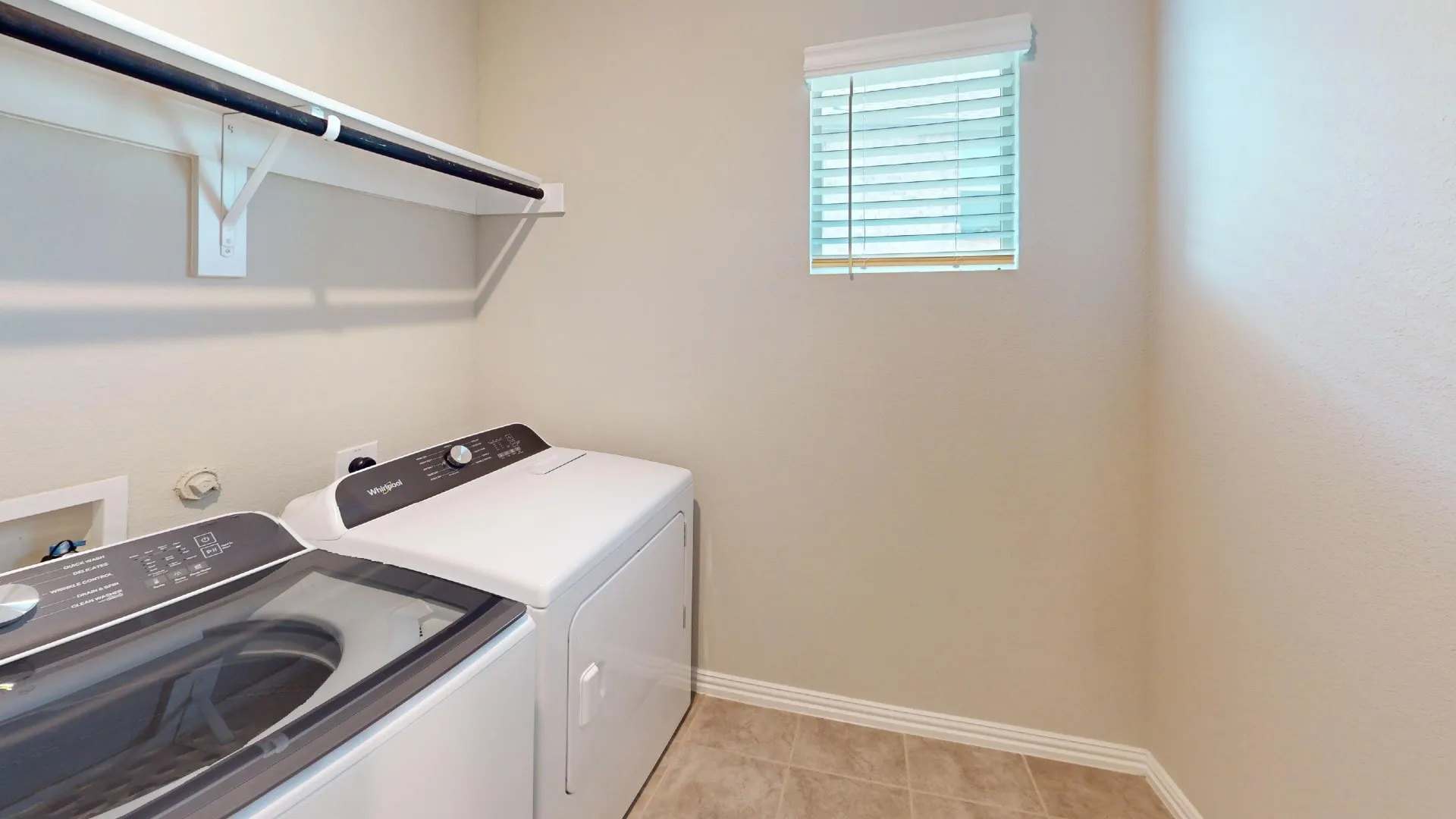 Tile flooring, built-in shelving, mounted clothes rod, window with blinds