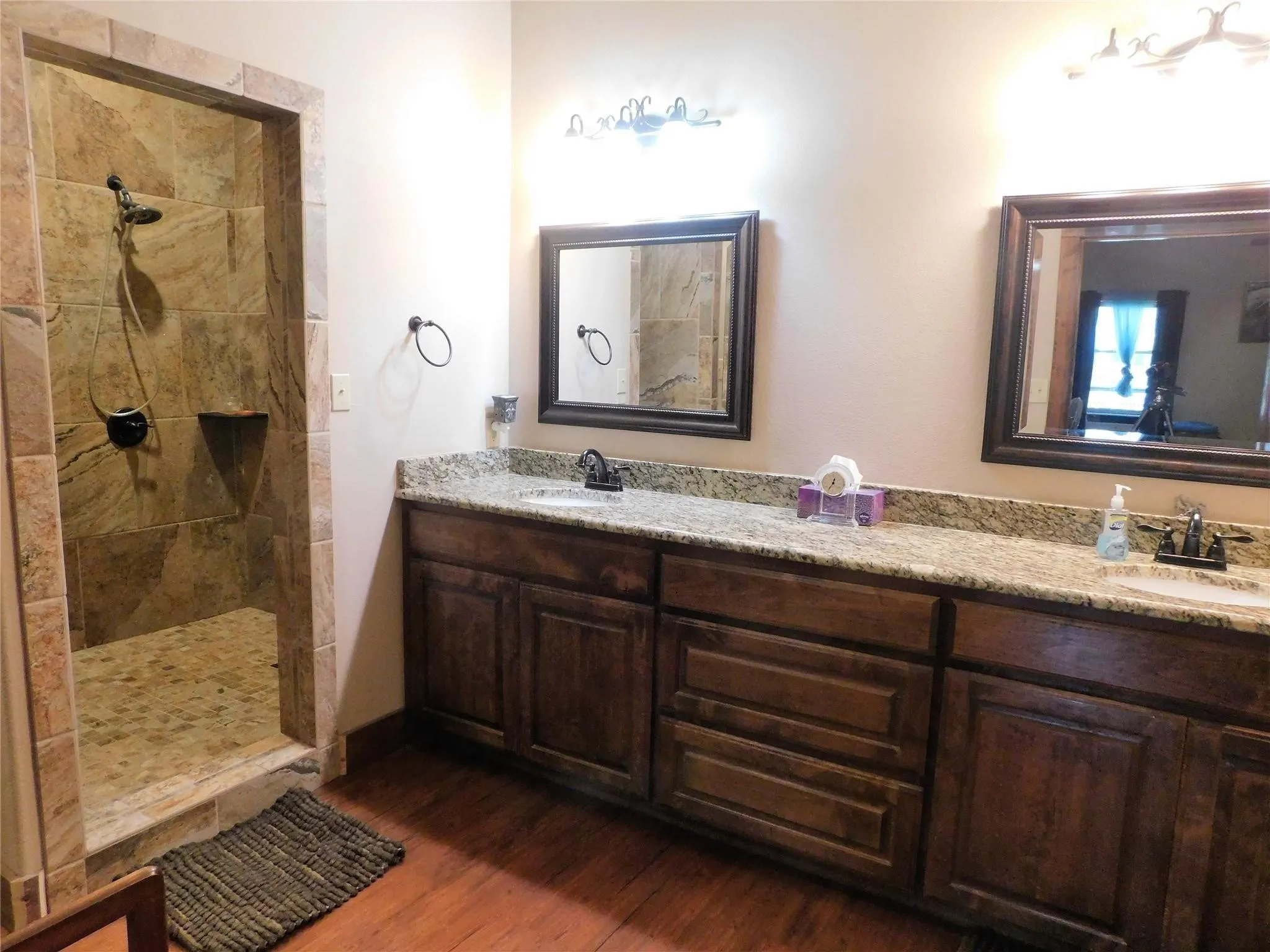 Your Private Home Spa: Spandrels of space featuring a custom-built tile and stone shower, twin granite sinks, and a huge closet.