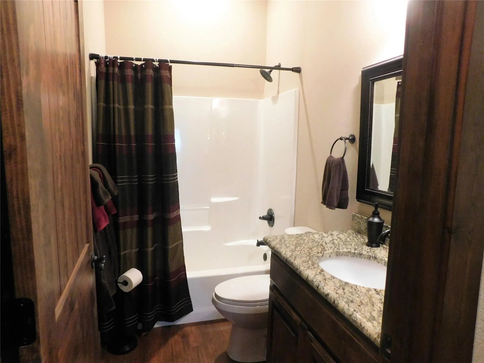 Hall Bathroom with granite counter tops and full shower and tub enclosure