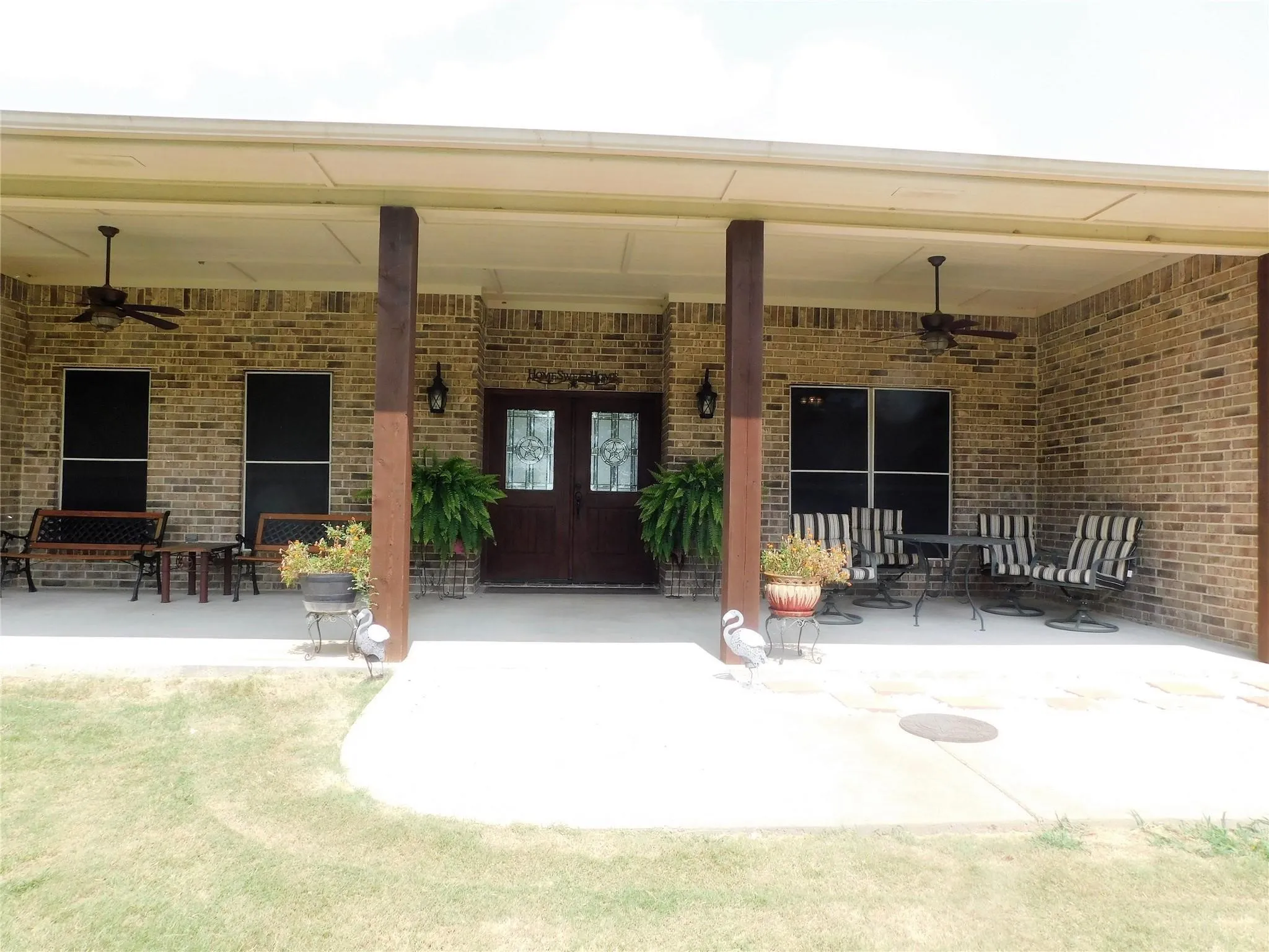 Double the impact with Stately wood double doors framed by a welcoming covered porch.