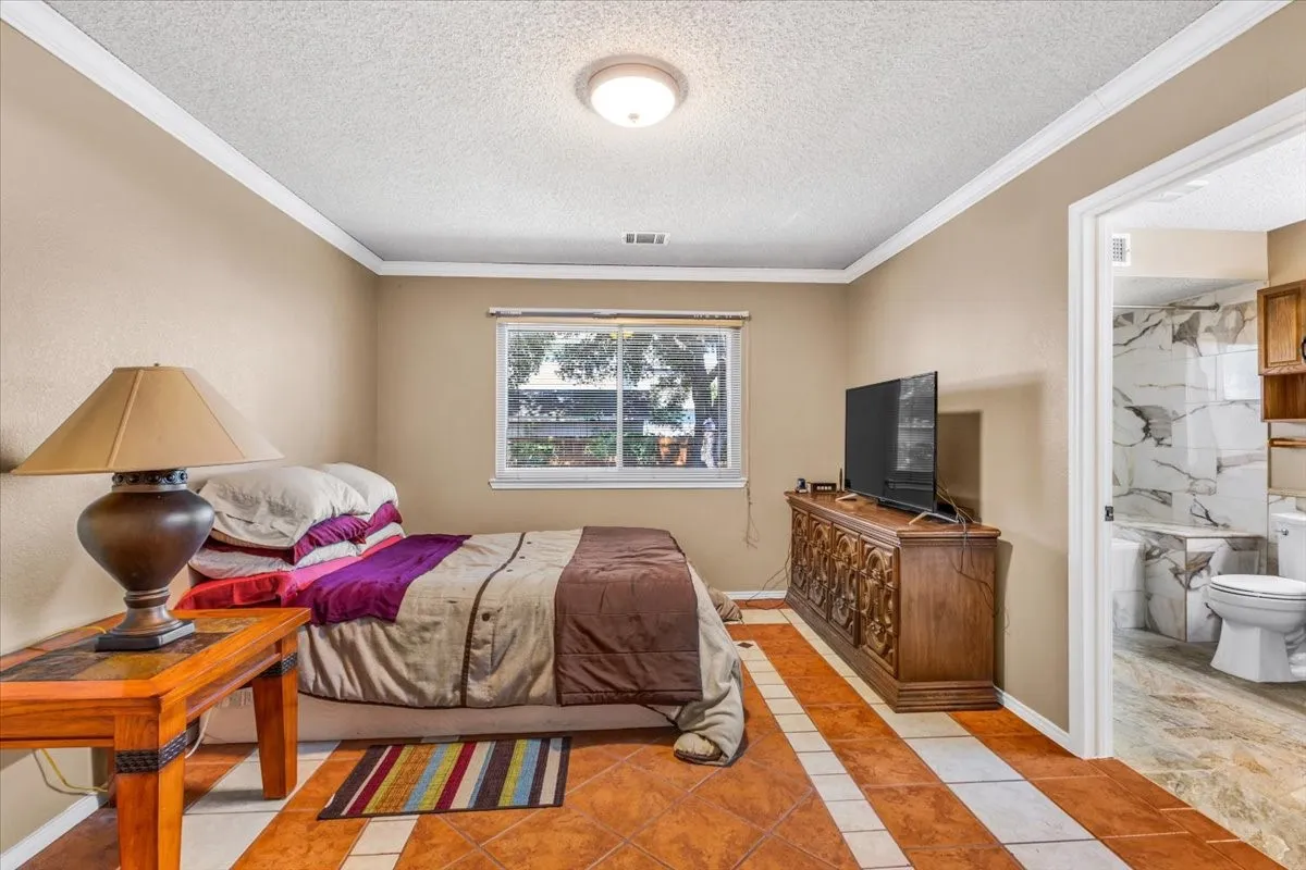 Neutral wall tones complement the tile flooring with accent stripes