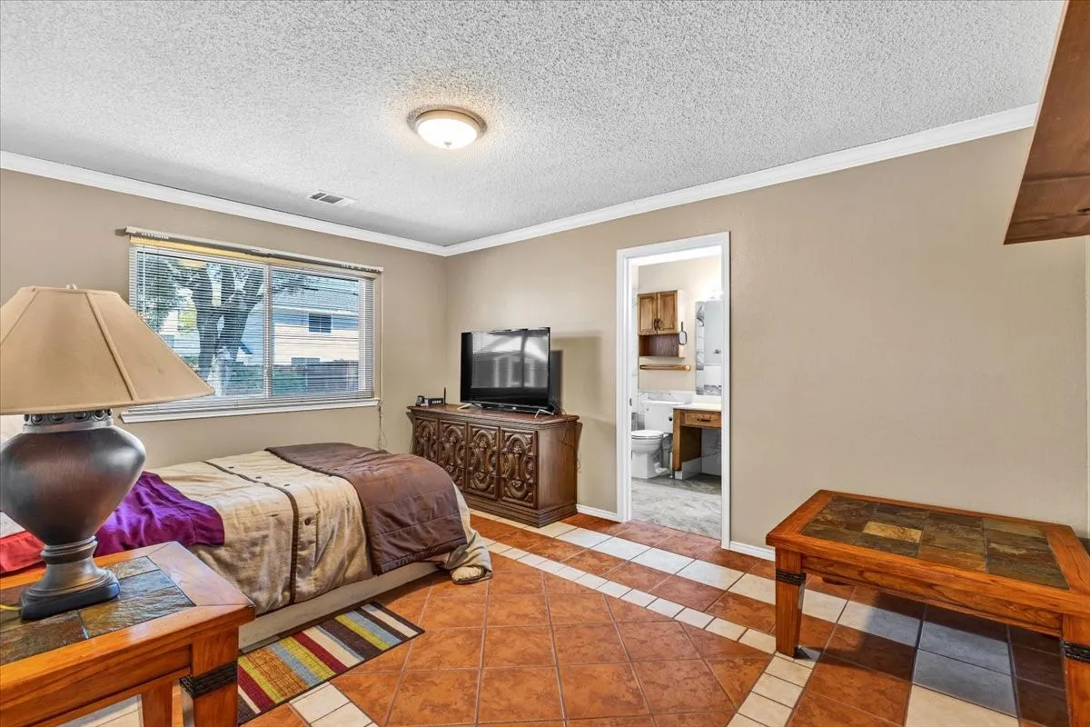 Recessed lighting and a flush mount fixture illuminate the room