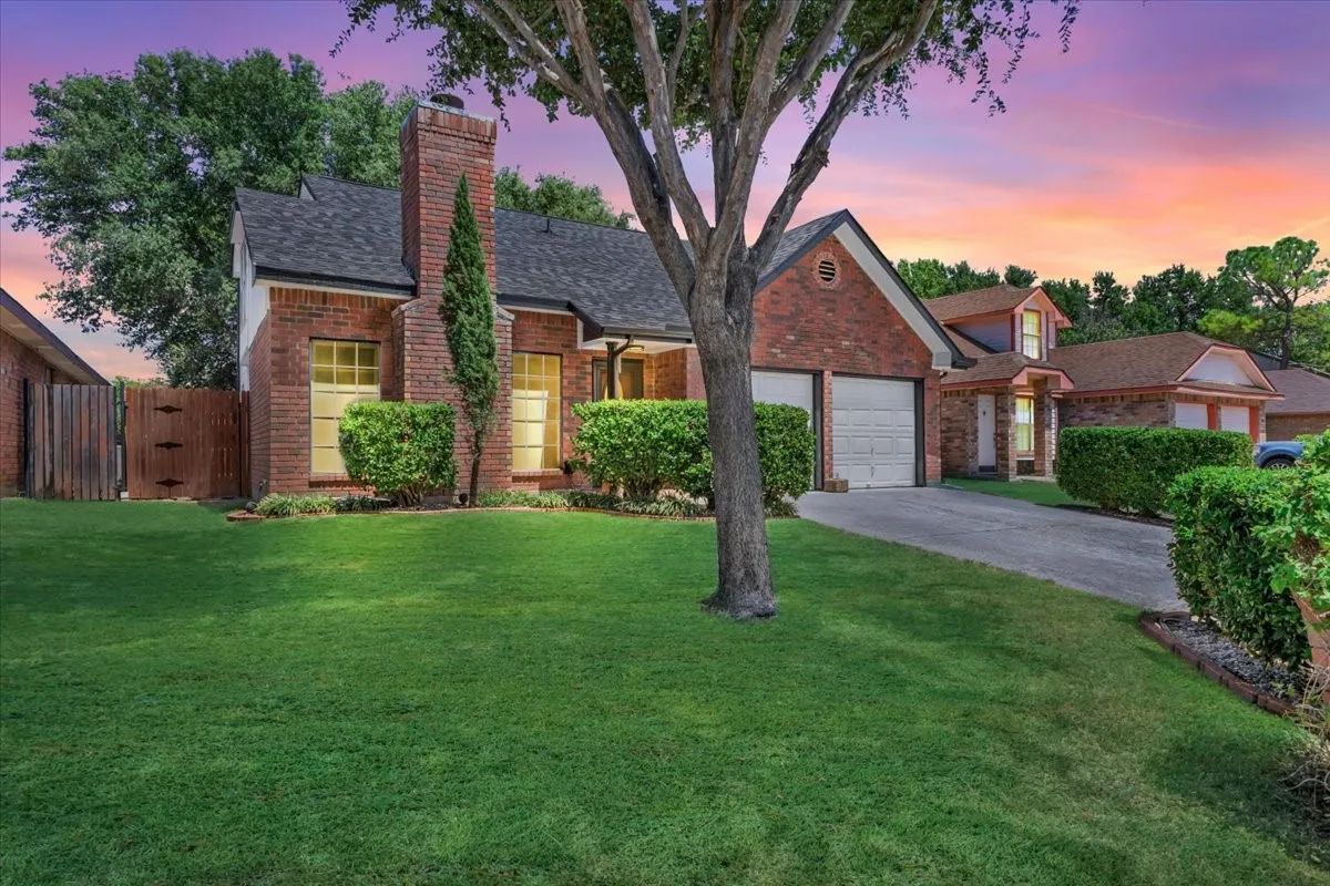 Brick exterior with a detached garage, an attached two-car garage, and a gabled roof