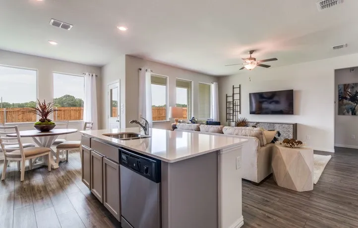 Open-concept living space featuring wood-finish flooring, recessed lighting, and a neutral color palette