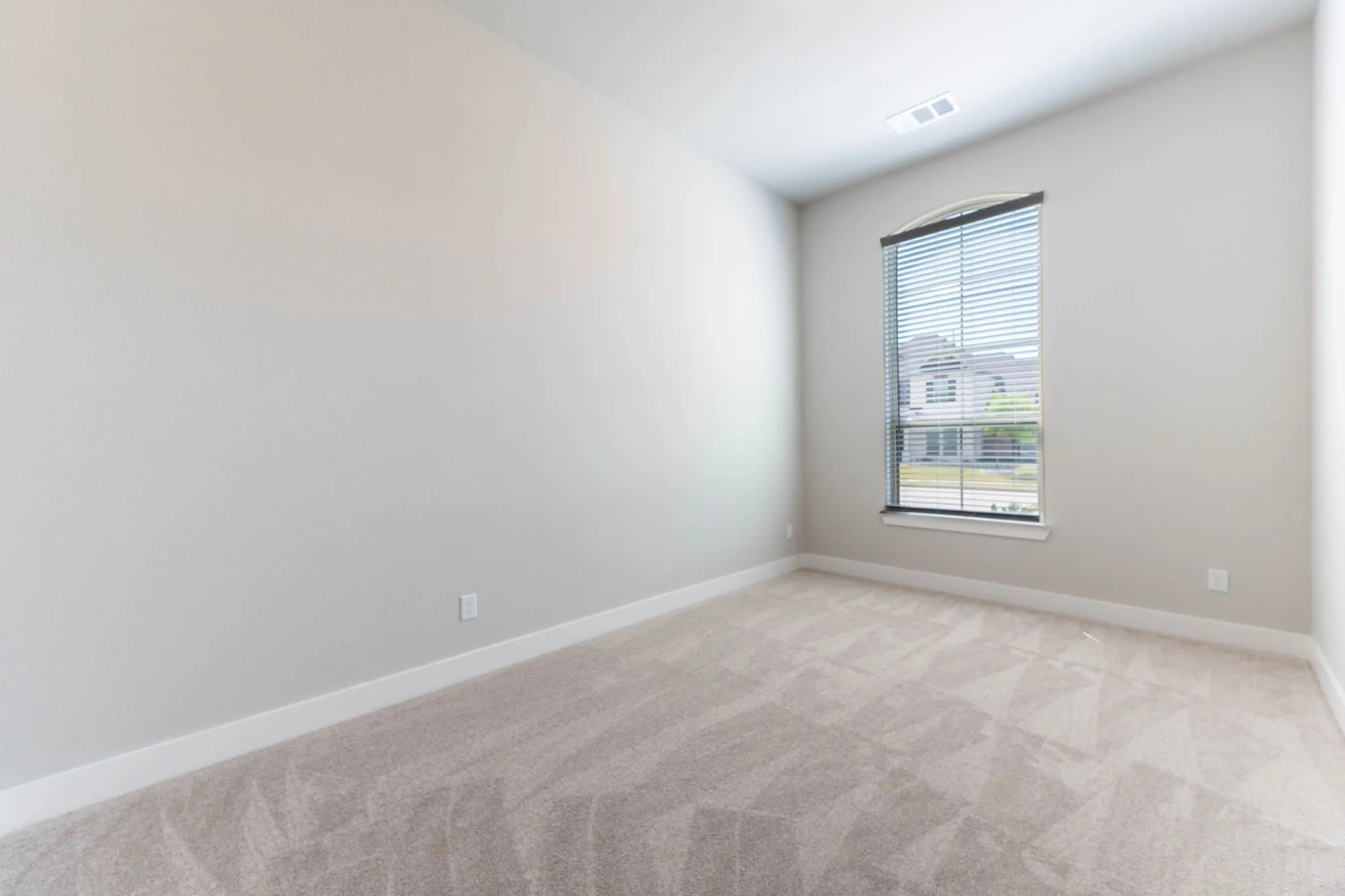 Neutral-toned walls complement plush carpet flooring