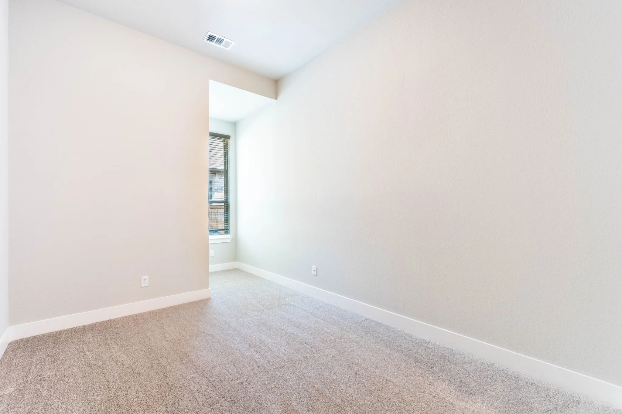 Wall-to-wall carpeting and neutral wall tones