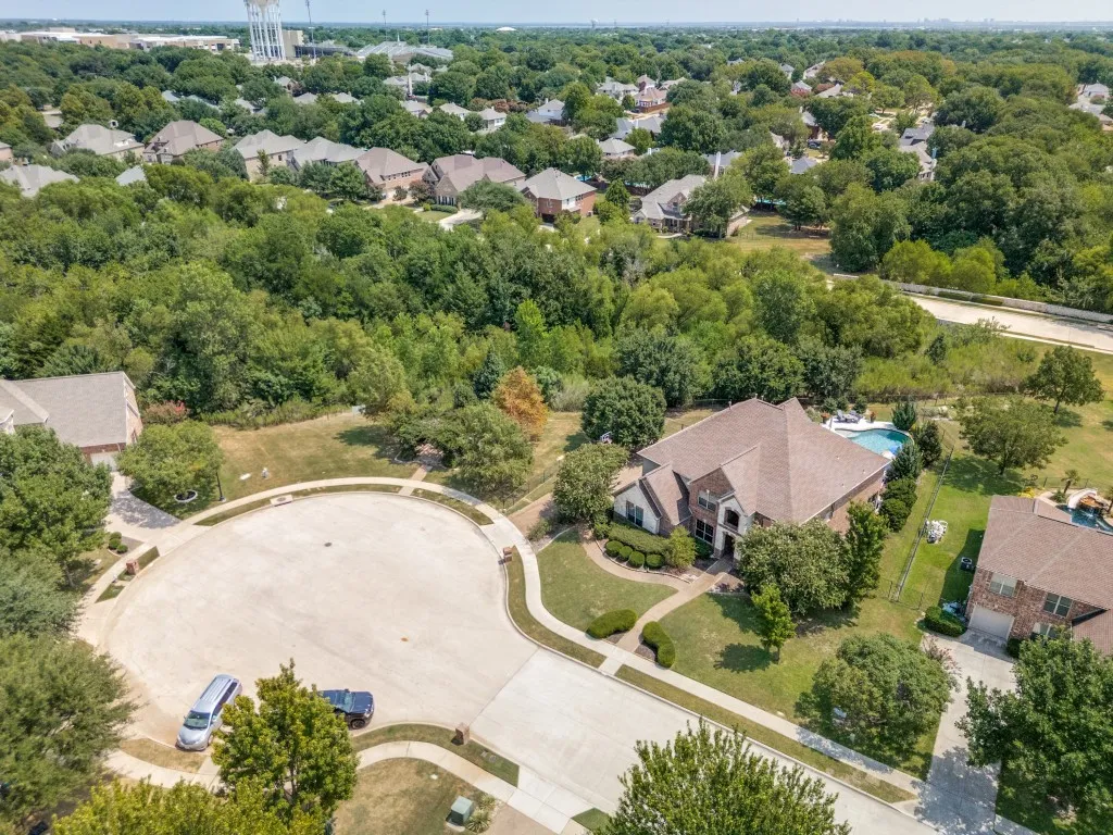 Rare cul-de-sac setting in The Reserve at Hickory Springs with the home positioned alongside a wooded protected greenbelt, offering exceptional privacy in the heart of Flower Mound.