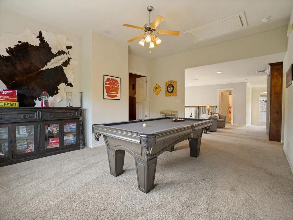 Expansive game room provides plenty of space for a pool table, game nights and entertaining, with the theatre room just steps away.