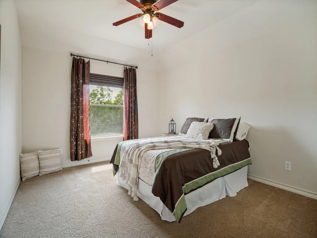 Spacious upstairs secondary bedroom with vaulted ceiling, walk-in closet and its own private ensuite bath—ideal for guests or extended stays.