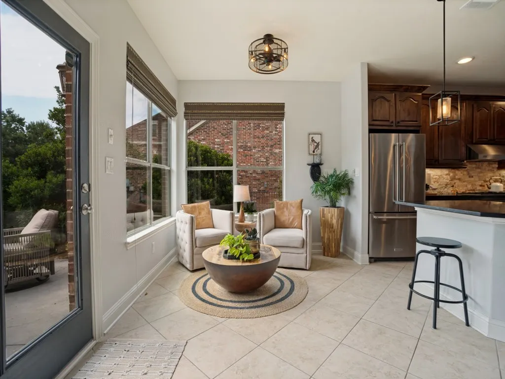 Light-filled breakfast area adjoining the renovated kitchen with large windows and easy access to the covered patio and backyard.