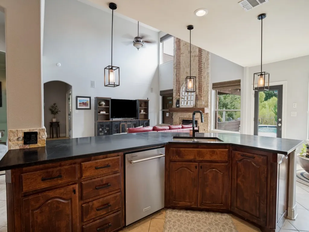 Thoughtfully designed kitchen with expansive counter space, abundant cabinetry and open sightlines into the two-story family room.