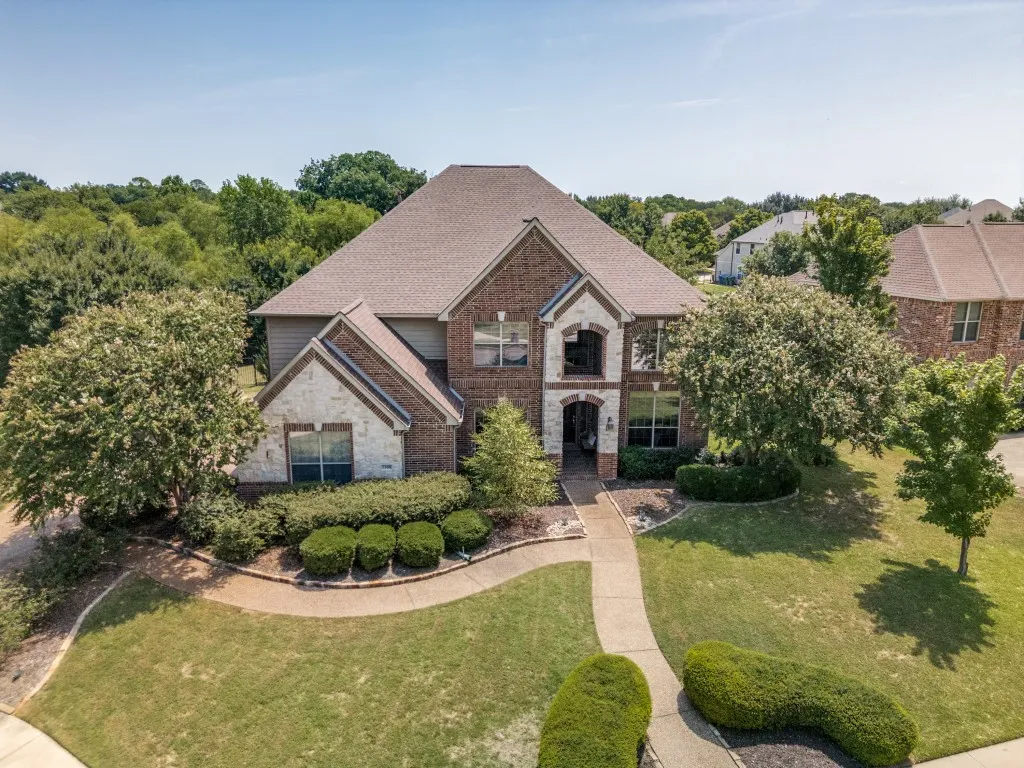 Impressive Toll Brothers home in The Reserve at Hickory Springs, ideally situated on a quiet cul-de-sac in Flower Mound with mature landscaping and a three-car garage.