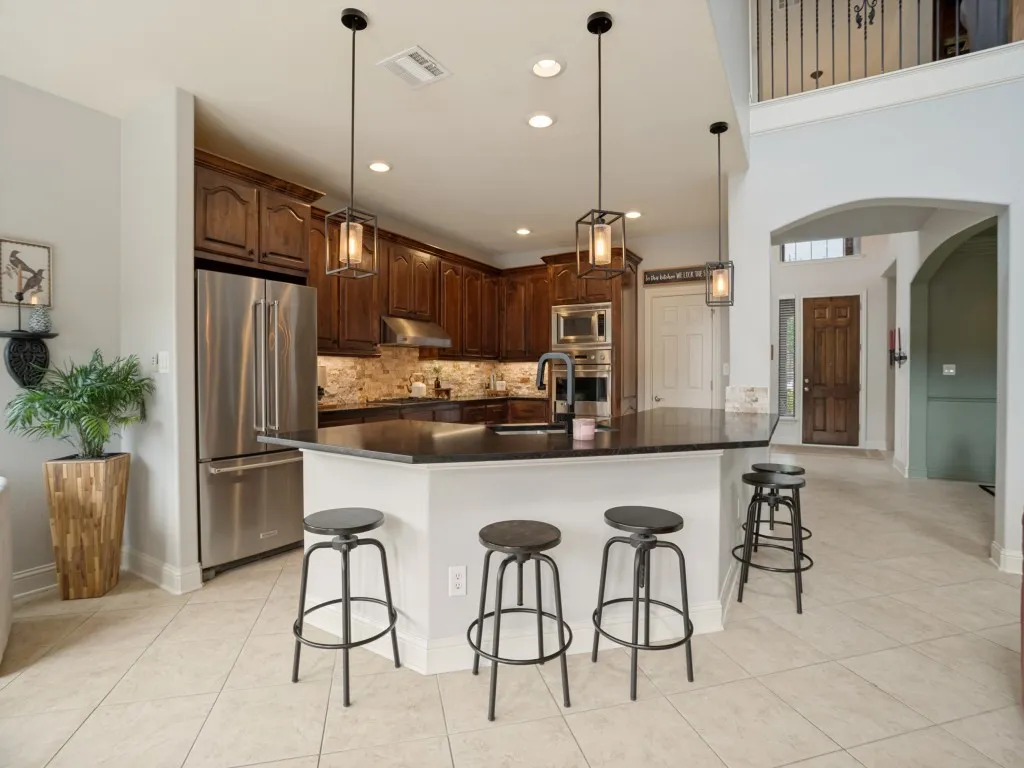 Spacious Flower Mound kitchen with breakfast bar, generous cabinetry and an open connection to the main living areas—designed for everyday living and entertaining.