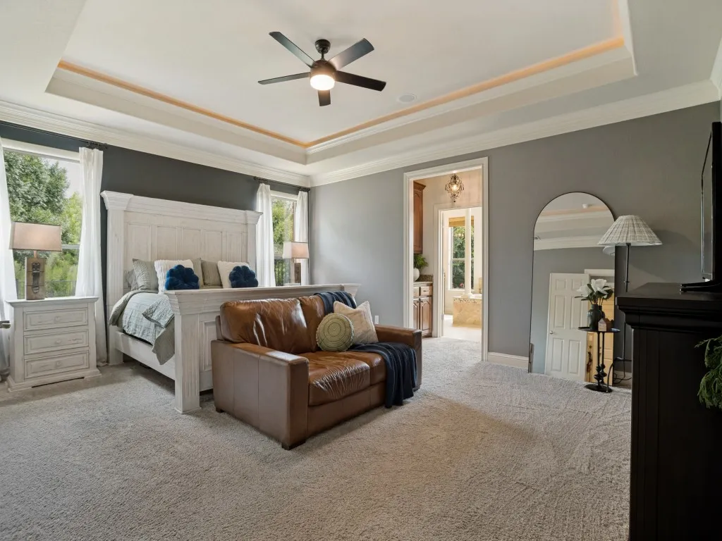 Expansive 20x16 first-floor primary suite with tray ceiling, sitting area and exceptional space for oversized furnishings.