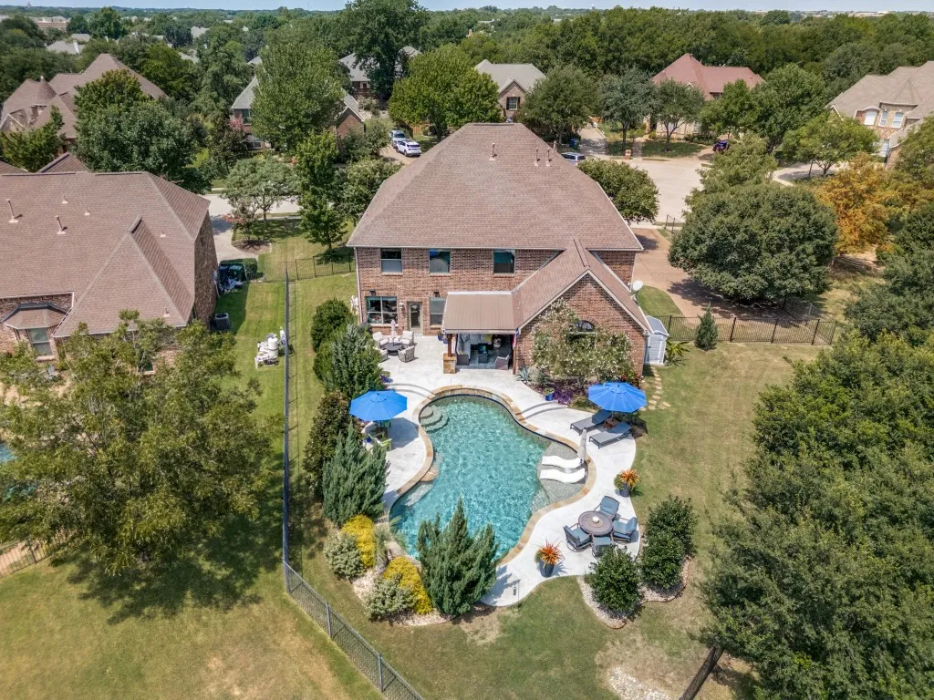 Resort-style pool, generous outdoor living space and lush landscaping come together on this .346-acre lot in The Reserve at Hickory Springs.