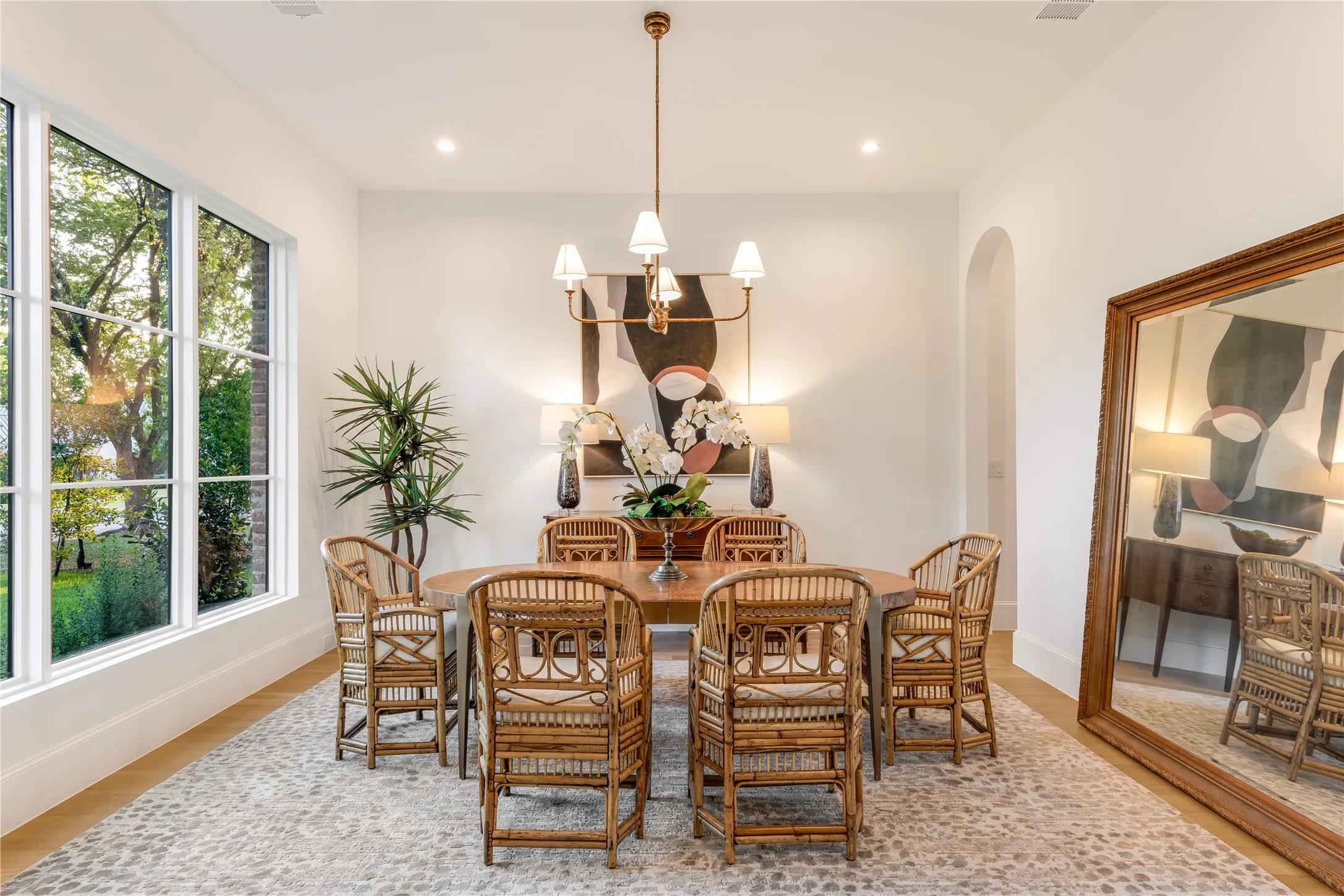 Spacious room featuring large gridded windows, recessed lighting, and a chandelier