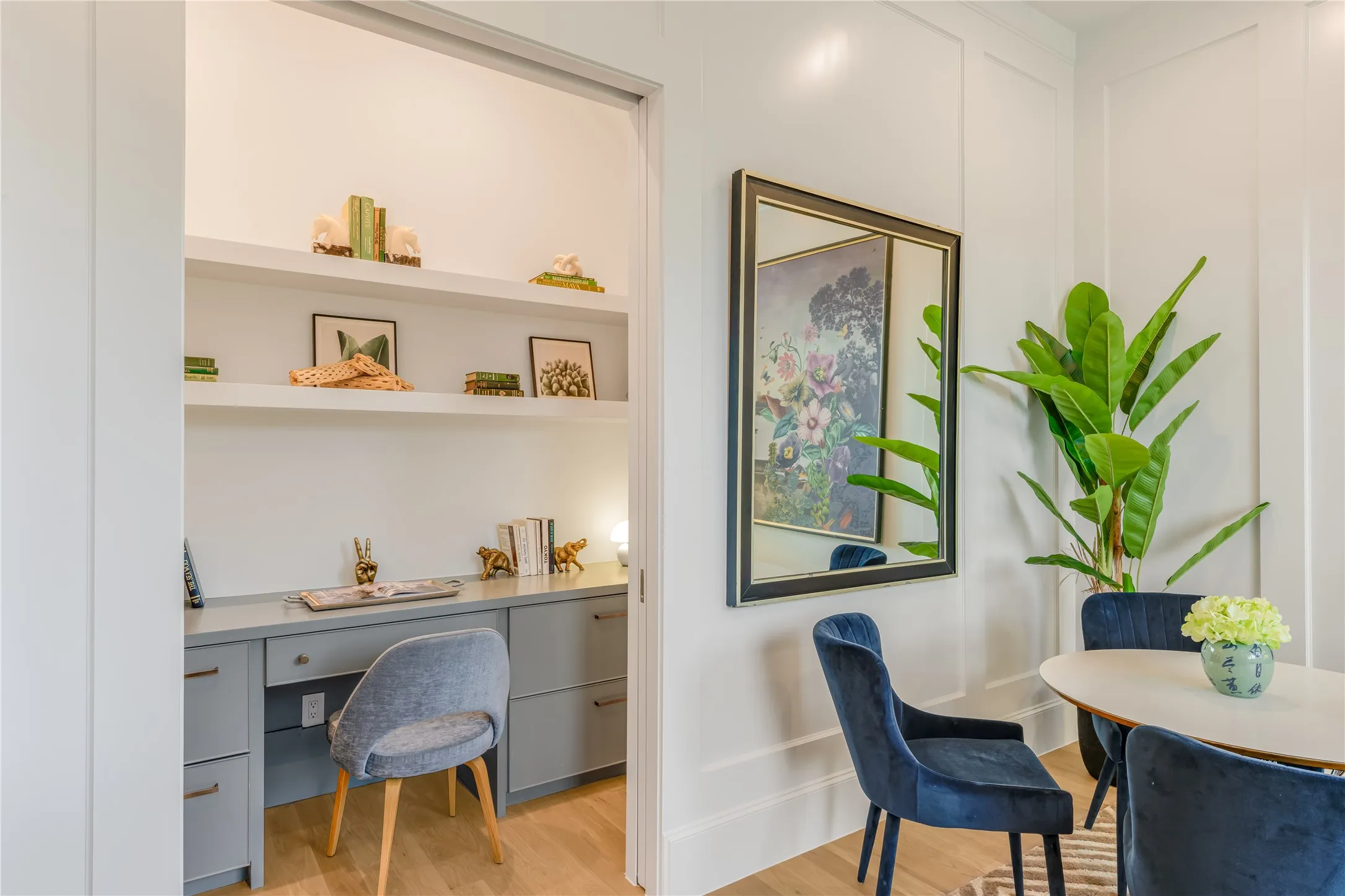 Built-in desk cabinetry with drawers, integrated shelving, and wood-finish flooring