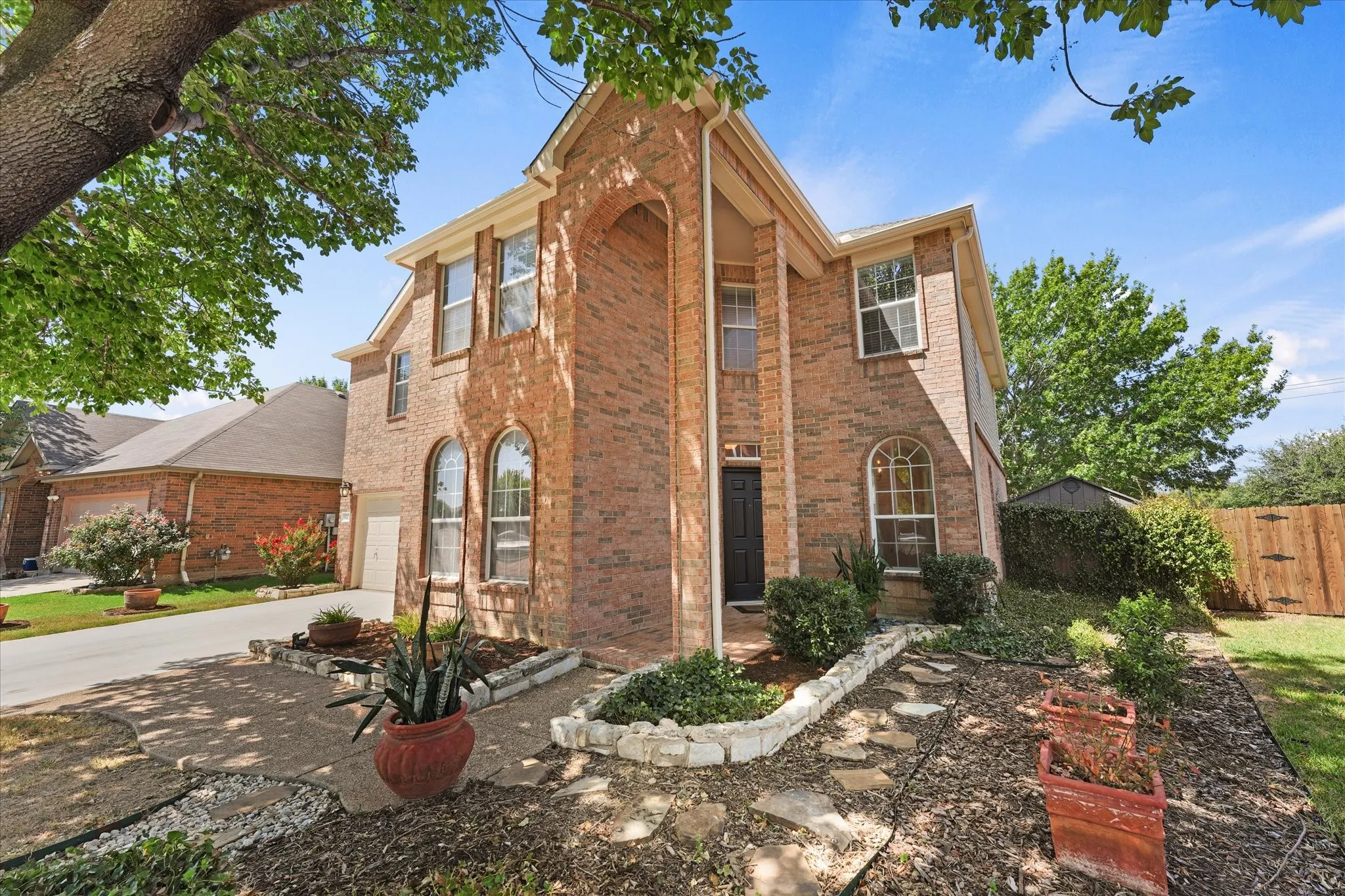 Meticulously cared for landscaping create stunning curb appeal. Pots and plants will convey with home if desired.