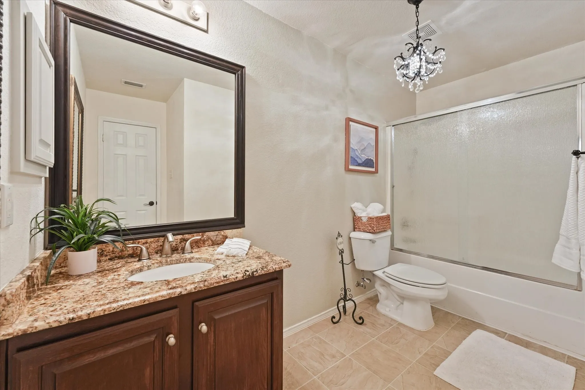 2nd full bath upstairs features ample space for additional storage and a vanity with granite countertop and integrated sink