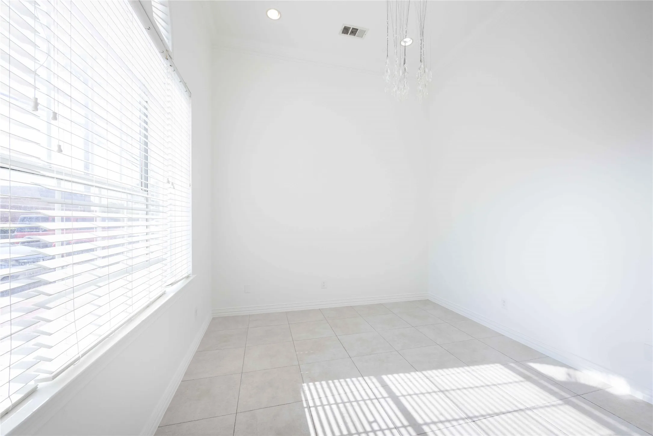 Recessed lighting, tile flooring, high ceilings, a decorative chandelier, and window blinds