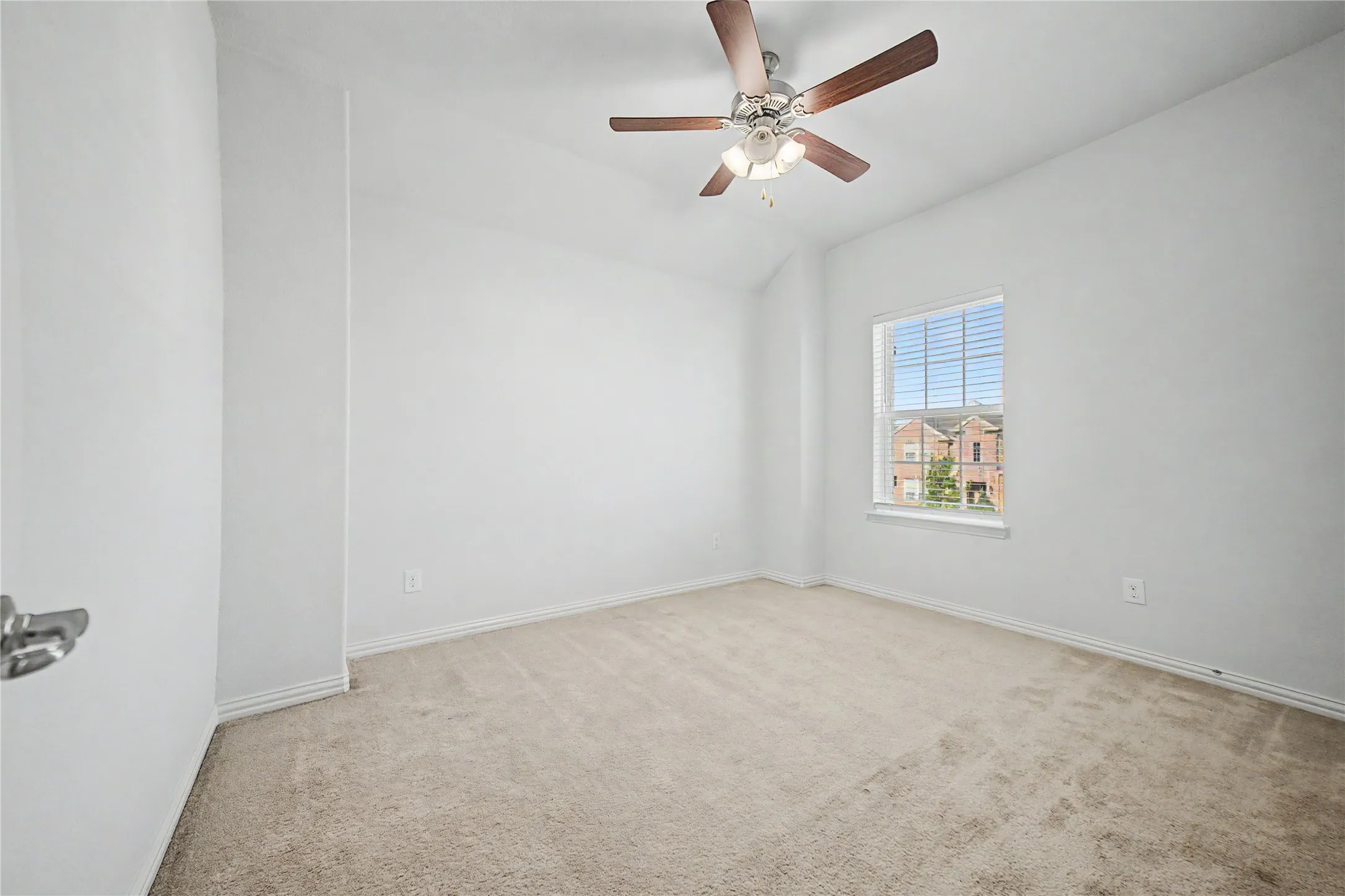 Vaulted ceiling, ceiling fan with light fixture, carpeted flooring, window with blinds, and white walls