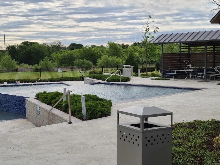 Dual-level swimming pool with a mosaic tile wall and integrated handrails