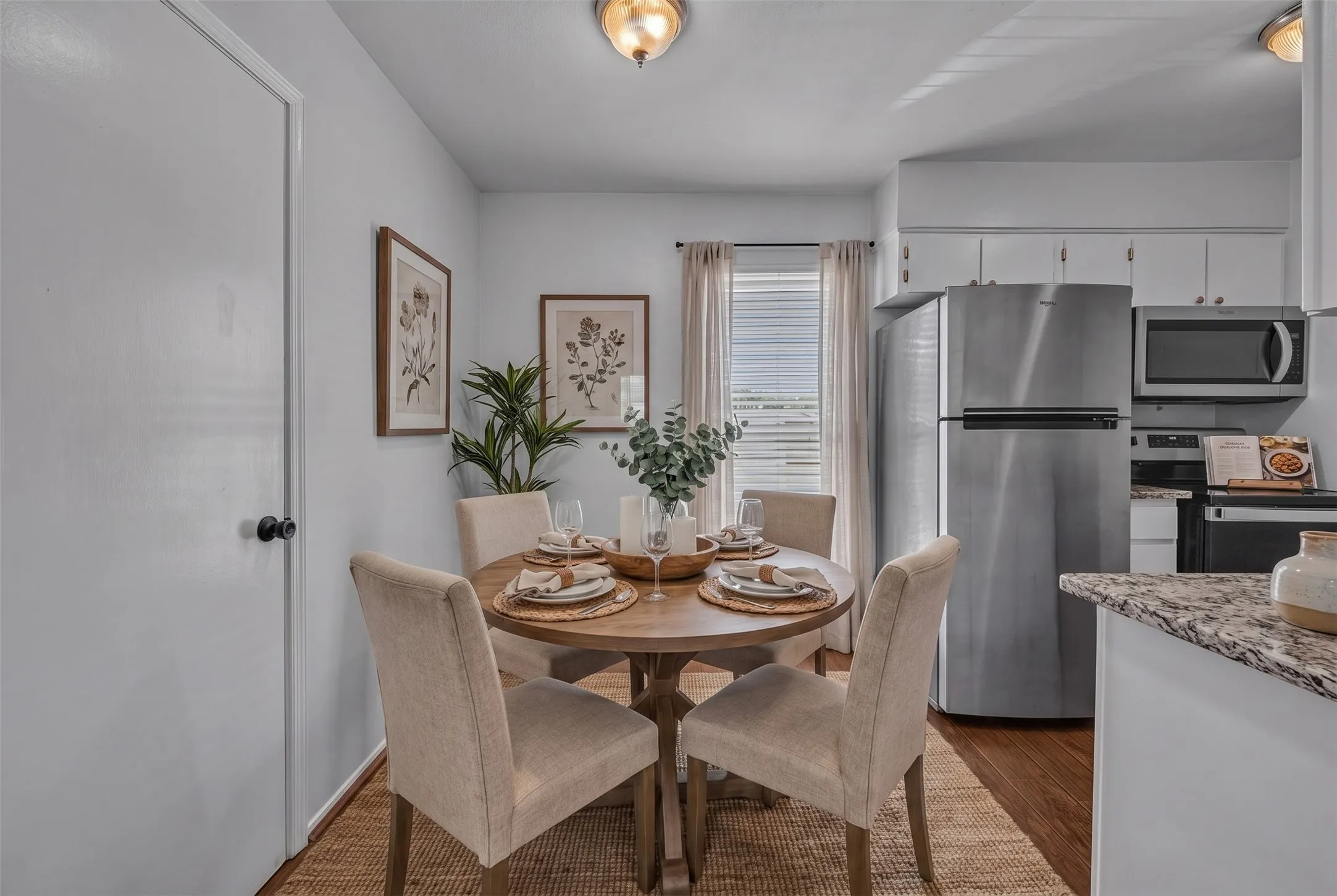 Kitchen featuring white cabinetry, stainless steel appliances, and stone-finish countertops