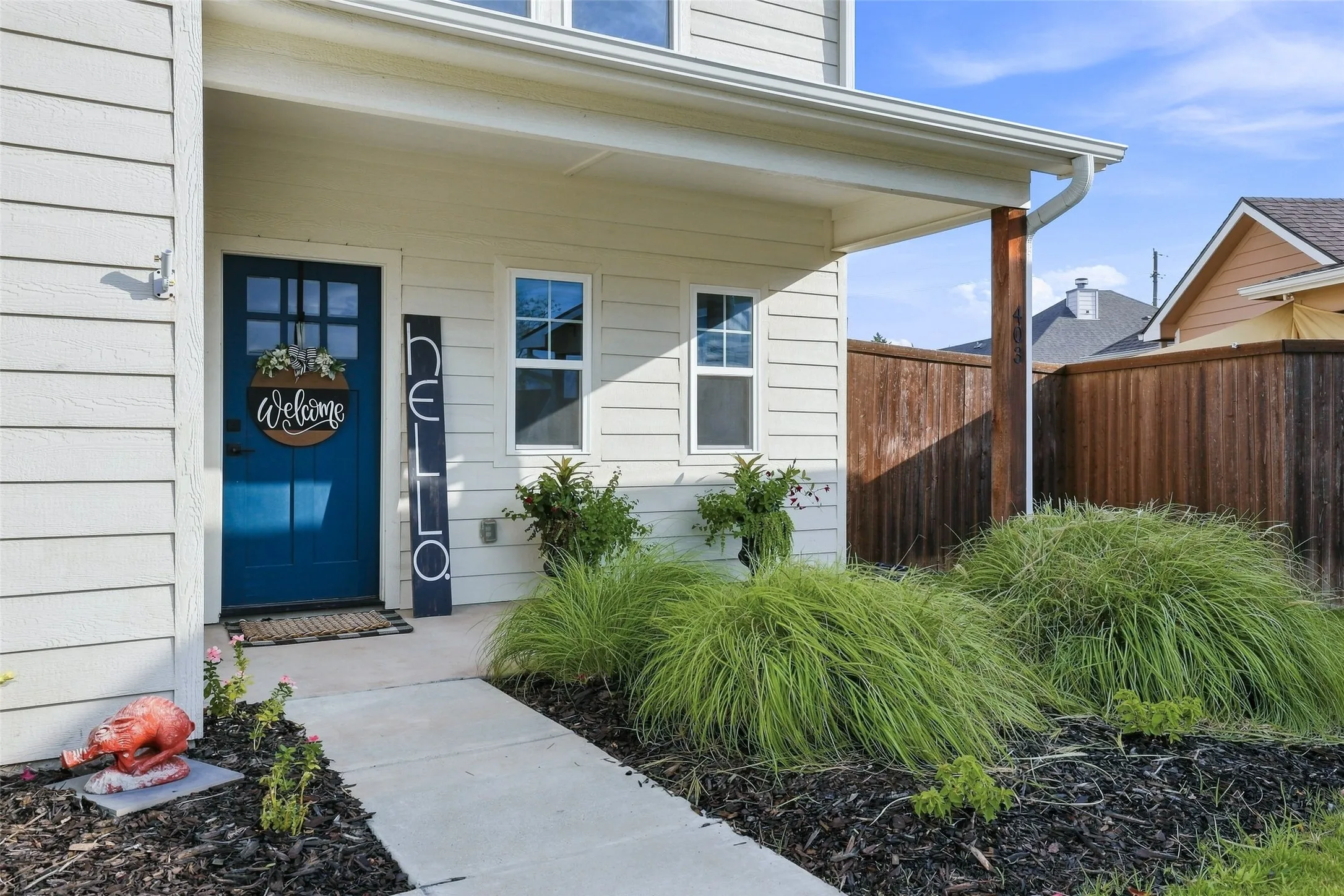 Covered porch entry featuring a deep blue door with window panes