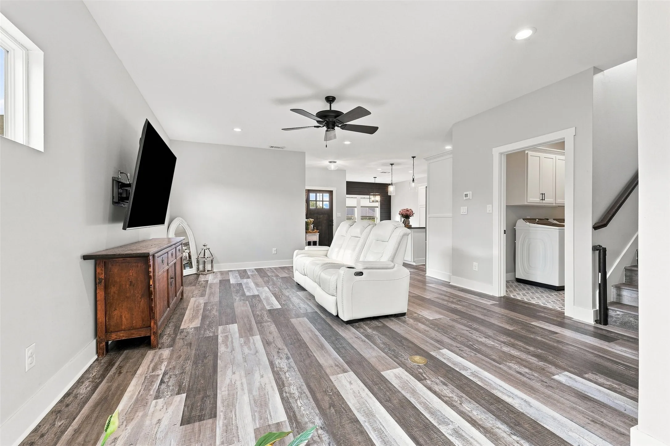 Spacious living area featuring wood-finish flooring, recessed lighting, a ceiling fan, and light gray wall tones