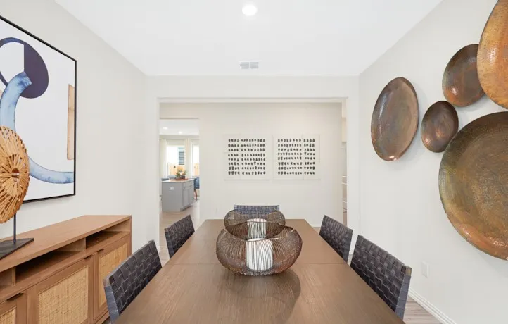 Dining area featuring light-toned walls and wood-finish flooring