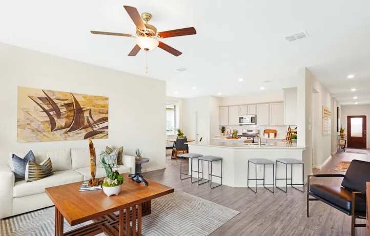 Open-concept living space featuring wood-finish flooring, recessed lighting, and a ceiling fan with integrated light fixture