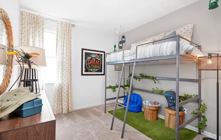 Carpeted room featuring a lofted metal bed frame with an integrated ladder, a window with patterned drapes, a wall-mounted framed artwork, and light gray wall paint