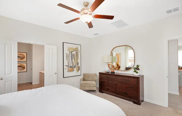 Spacious room featuring light-colored walls and soft carpeting