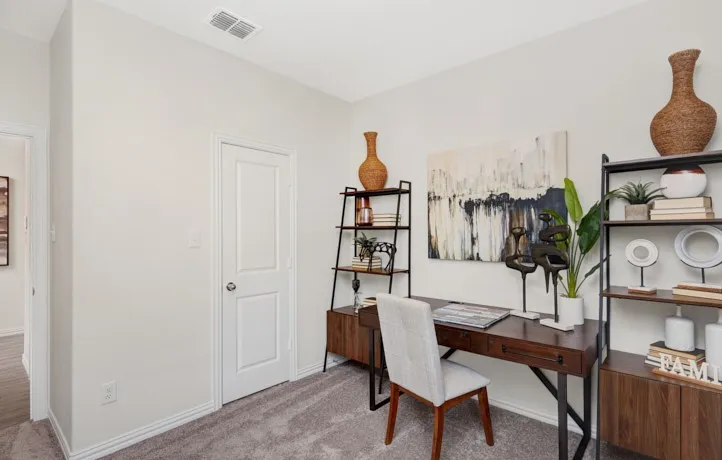 Neutral-toned room featuring light gray carpeting and white trim