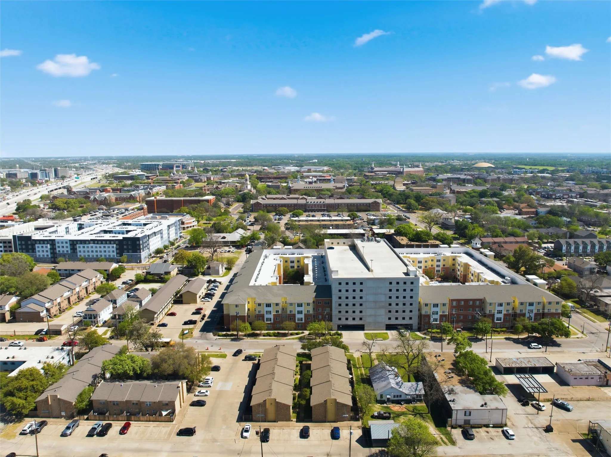Urban neighborhood setting with diverse architectural styles and mature trees
