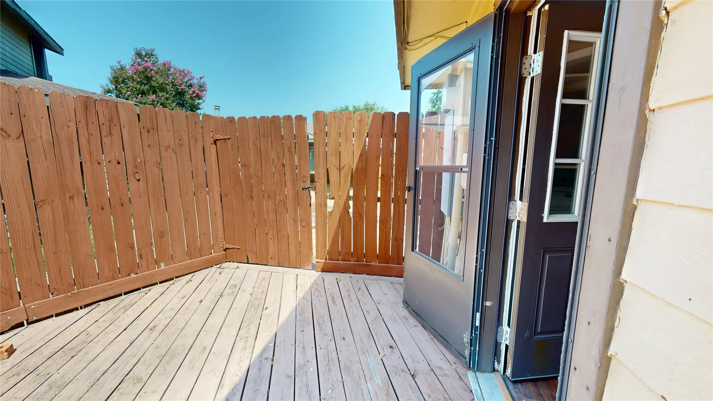 Wood decking with full privacy fencing and a secure gate