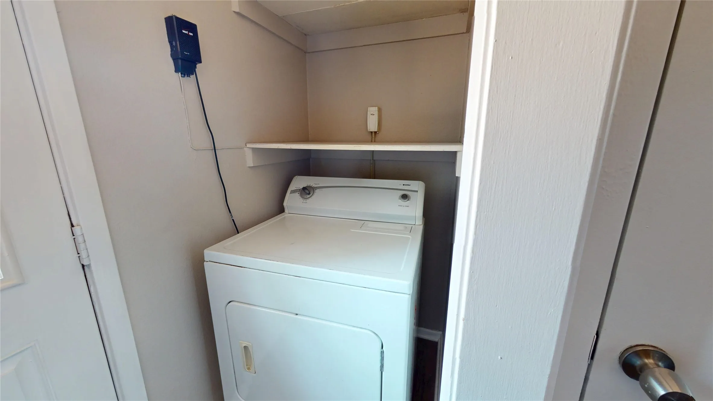 Dedicated laundry area with a built-in shelf