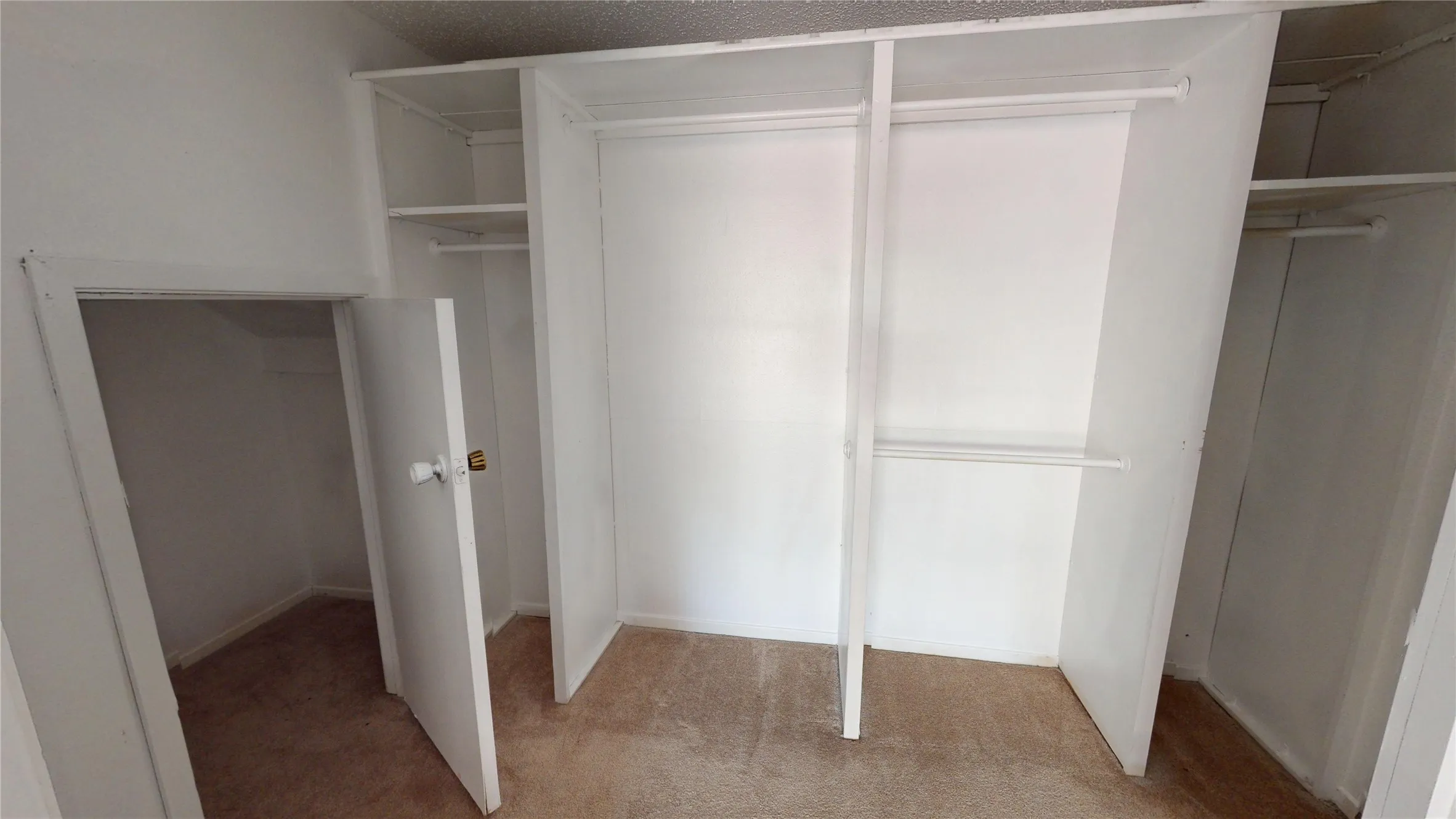 Built-in closet system with shelving and hanging rods