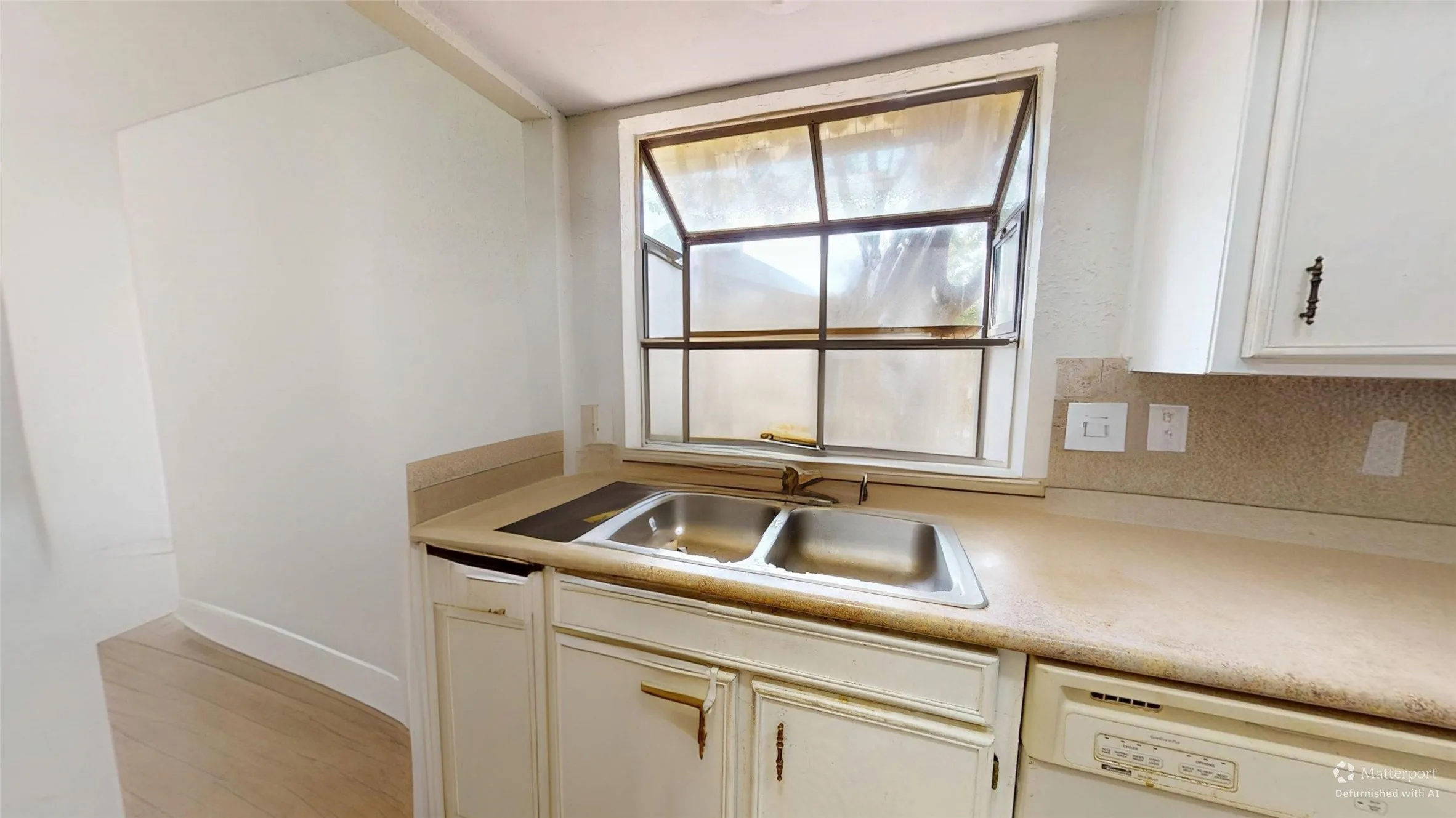 Double basin stainless steel sink with a window overhead
